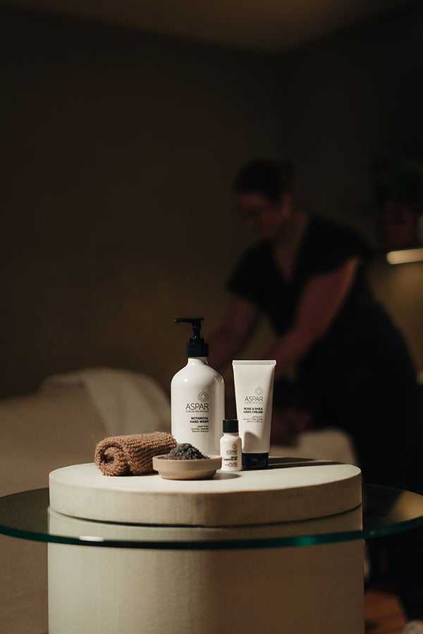 Bathroom setting with skincare products on a round table, blurred background
