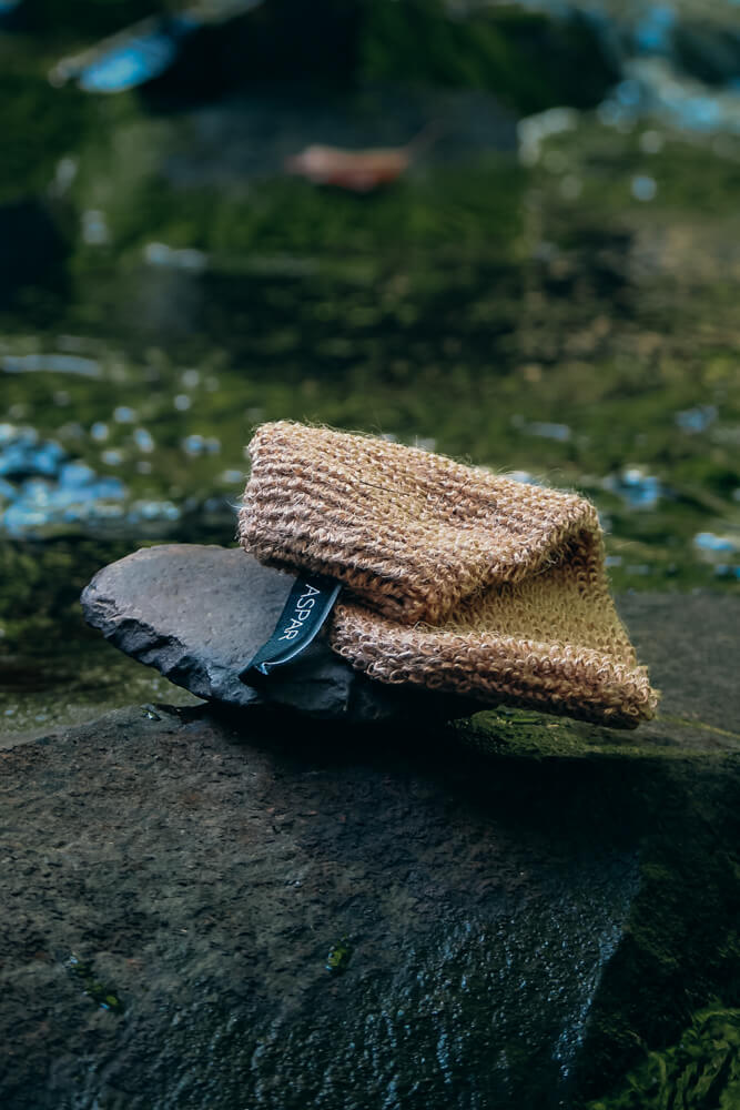 Pair of brown and black shoes on a textured surface with a blurred natural background