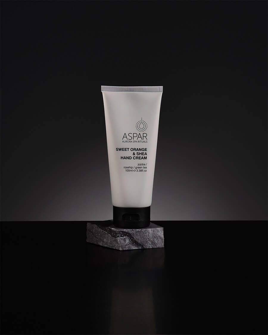 Tube of Aspar hand cream on a dark background