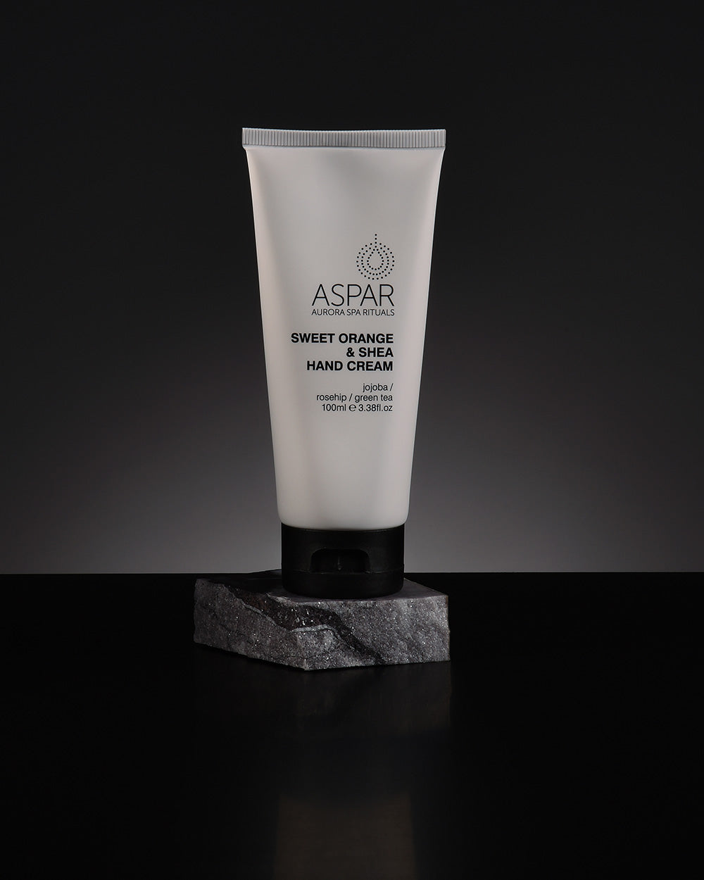 Tube of Aspar Sweet Orange & Shea Hand Cream on a dark background