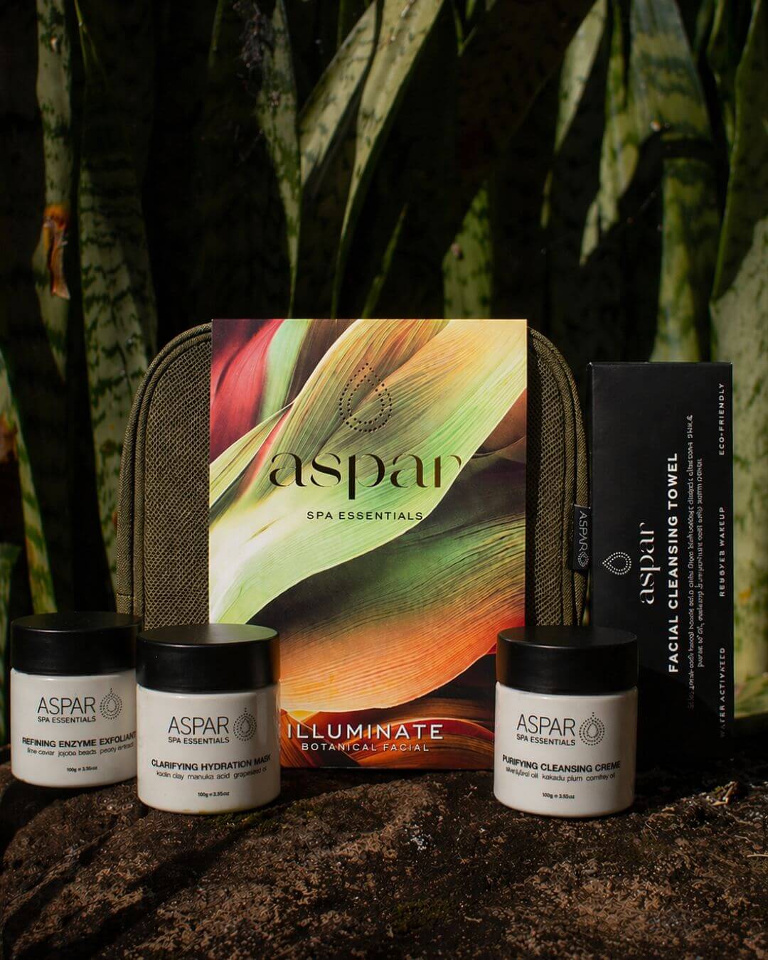 Aspar spa essentials set with jars and a pouch against a natural background