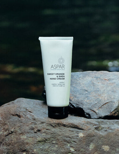 Tube of Aspar hand cream on a rock with a natural background